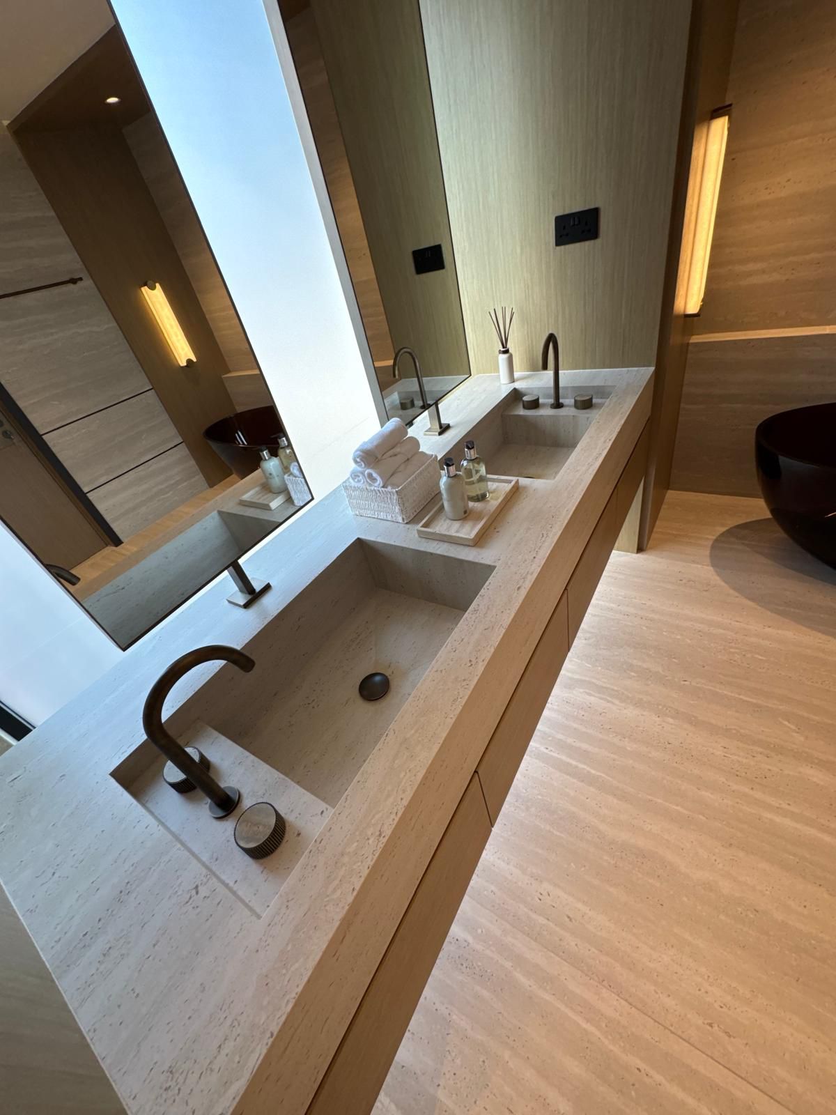 Premium travertine double vanity bathroom completed by Sabbaq Fannan Al Riyadh in Riyadh
