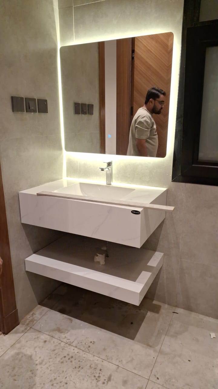 Modern wall-mounted marble basin with LED mirror fitted by Sabbaq Fannan Al Riyadh
